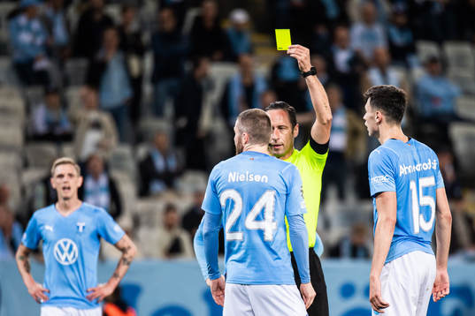 Lasse Nielsen of Malmö FF receives a warning from referee