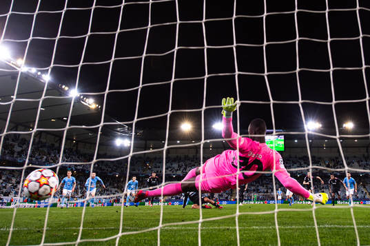 Paulo Dybala of Juventus scores a penalty behind goalkeeper