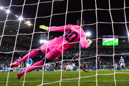 Paulo Dybala of Juventus scores a penalty behind goalkeeper