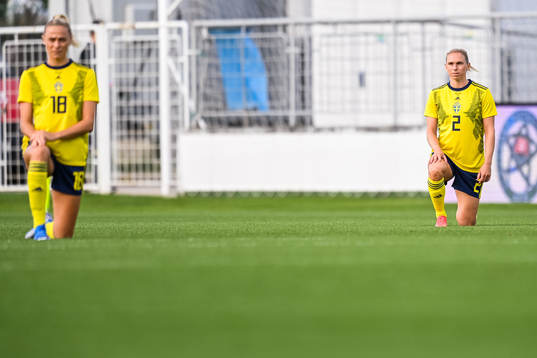 Fridolina Rolfö and Jonna Andersson of Sweden kneel in