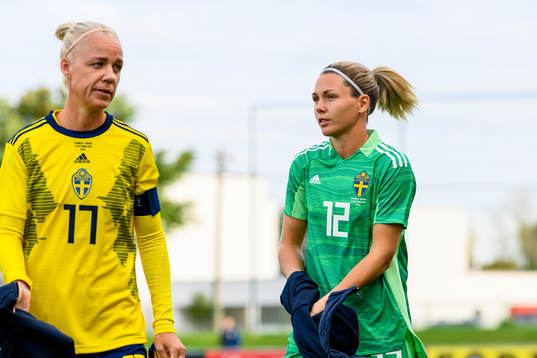 Caroline Seger and goalkeeper Jennifer Falk of Sweden