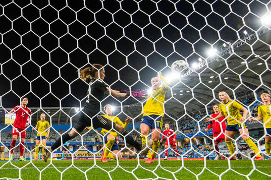 Caroline Seger of Sweden scores 4-0 behind goalkeeper Tatia