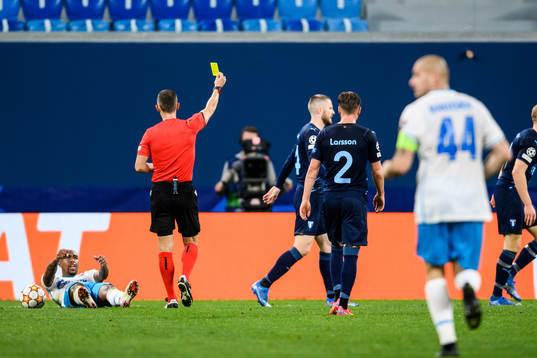 Franz Brorsson of Malmö FF is shown a yellow card by