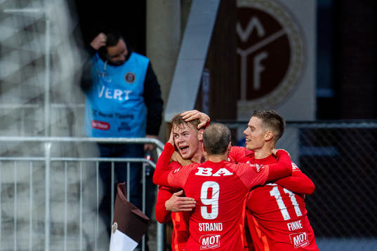 Robert Taylor of Brann celebrates with teammates Aune