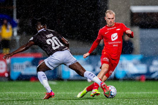 Isaac Twum of Mjøndalen and Petter Strand of Brann