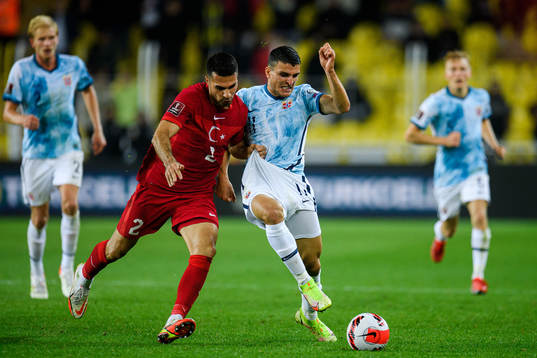 Zeki Celik of Turkey and Mohamed Elyounoussi of Norway