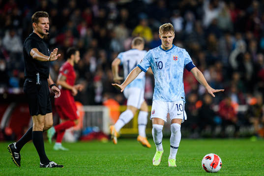 Felix Brych, referee, and Martin Ødegaard of Norway