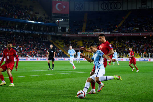 Mohamed Elyounoussi of Norway and Zeki Celik of Turkey