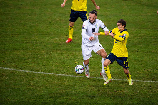 Vedat Muriqi of Kosovo and Kristoffer Olsson of Sweden
