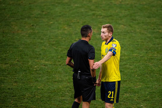 Dejan Kulusevski of Sweden and referee Marco Di Bello