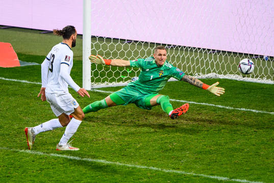 Vedat Muriqi of Kosovo and goalkeeper Robin Olsen of Sweden