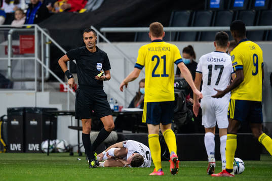 Dejan Kulusevski of Sweden is shown a yellow card by