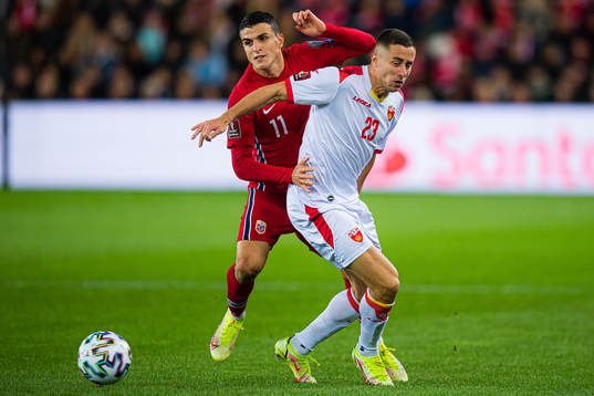 Mohamed Elyounoussi of Norway and Adam Marusic of Montenegro