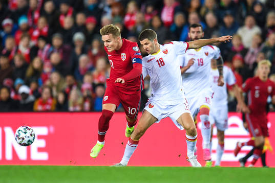 Martin Ødegaard of Norway and Nebojsa Kosovic of Montenegro