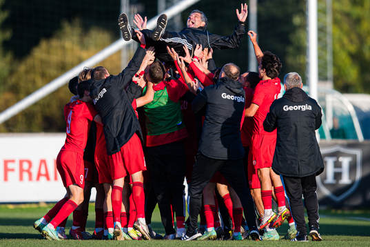 Players of Georgia celebrates with Vasil Maisuradze, head