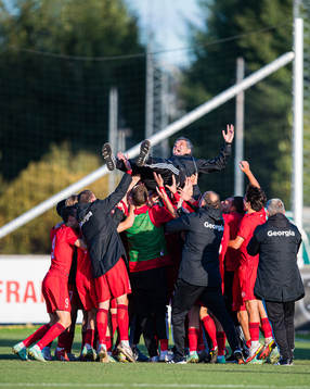 Players of Georgia celebrates with Vasil Maisuradze, head