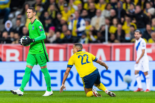 Goalkeeper Odisseas Vlachidimos of Greece as Robin Quaison