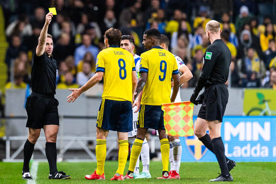 Albin Ekdal of Sweden receives a yellow card from referee