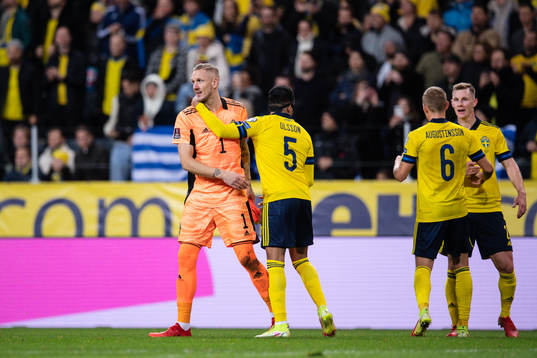 goalkeeper Robin Olsen and Martin Olsson of Sweden celebrate