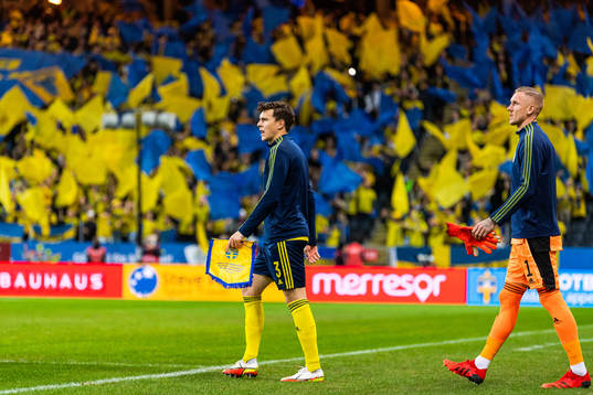 Victor Nilsson Lindelöf and goalkeeper Robin Olsen enter