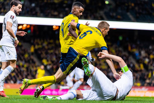 Alexander Isak and Ludwig Augustinsson of Sweden compete