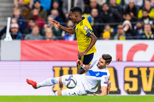 Alexander Isak of Sweden is tackled byKonstantinos