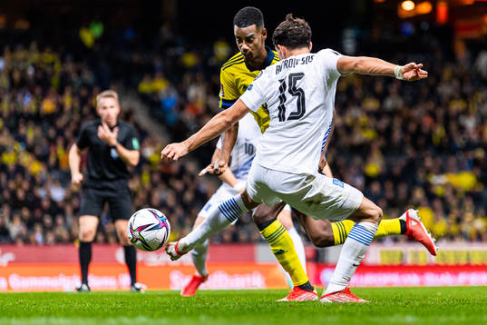Alexander Isak of Sweden drives the ball past Thanasis