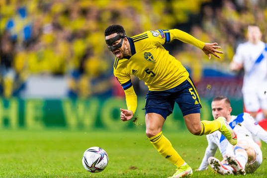 Martin Olsson of Sweden drives the ball past Dimitris