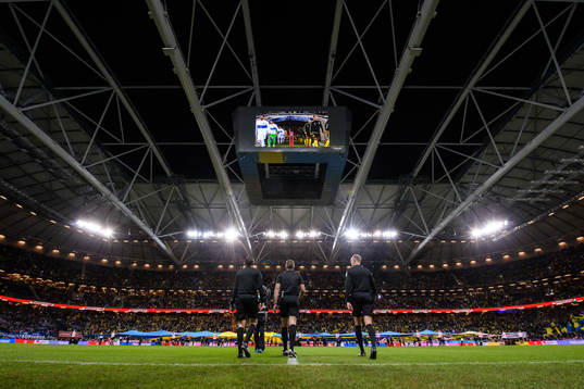 The referees enter the pitch for the FIFA World Cup