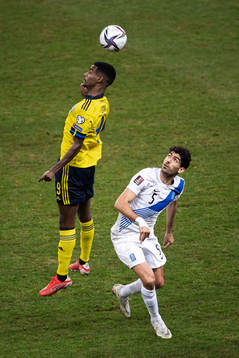 Alexander Isak of Sweden and Andreas Bouchalakis of Greece