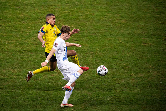 Robin Quaison of Sweden and Kostas Tsimikas of Greece