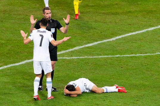Giorgos Masouras of Greece and referee Tobias Stieler
