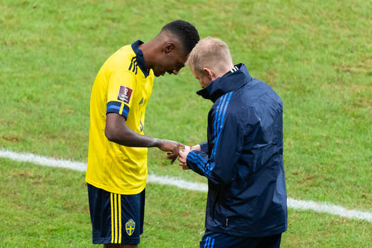 Alexander Isak of Sweden receives medical treatment to his