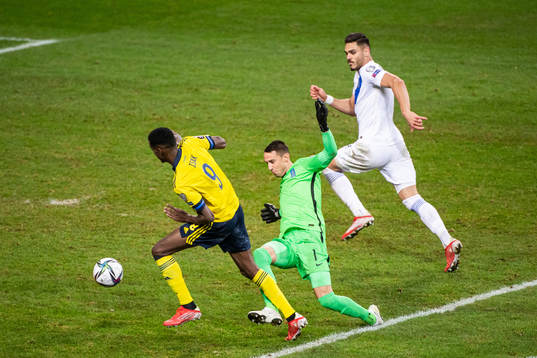 Alexander Isak of Sweden and goalkeeper Odisseas