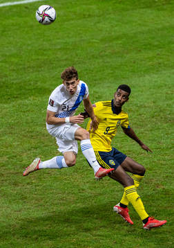Kostas Tsimikas of Greece and Alexander Isak of Sweden