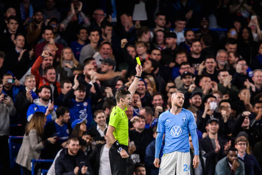 Lasse Nielsen of Malmö FF is shown a yellow card by