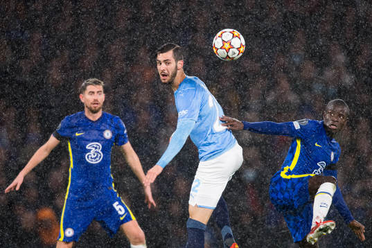 Adi Nalic of Malmö FF against Jorginho and N'Golo Kante of