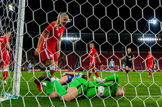 Paulina Dudek and goalkeeper Karolina Klabis of Poland