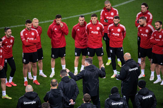 Players listen to head coach Willy Sagnol of the Georgian