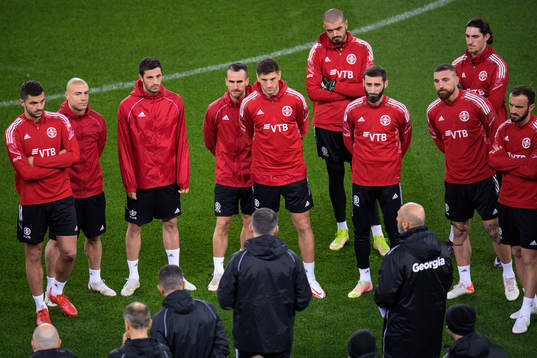 Players listen to head coach Willy Sagnol of the Georgian