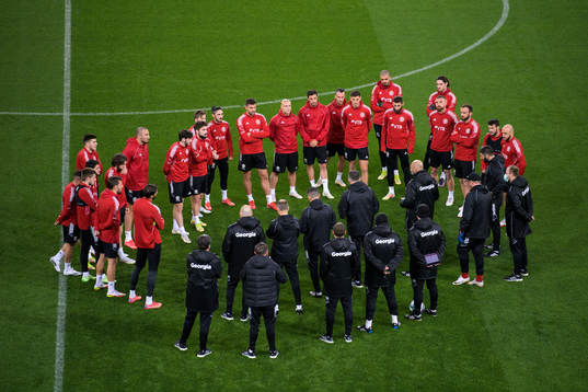 Players listen to head coach Willy Sagnol of the Georgian