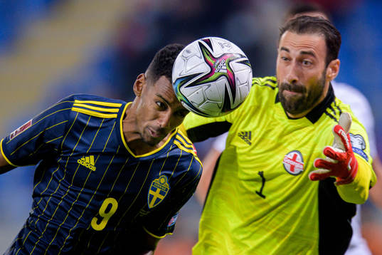 Alexander Isak of Sweden and goalkeeper Giorgi Loria of