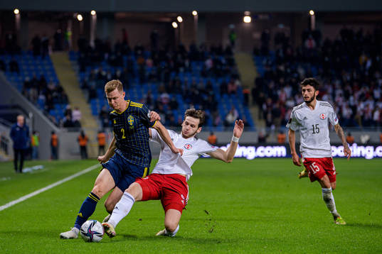 Emil Krafth of Sweden against Khvicha Kvaratskhelia and