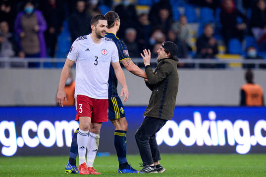 A pith invader next to Zlatan Ibrahimovic of Sweden