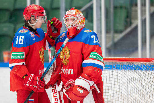 Daniil Kuzmin and goalkeeper Yegor Guskov of Russia