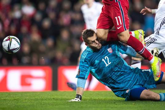 Mohamed Elyounoussi of Norway hits goalkeeper Roberts Ozols