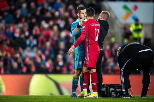 Goalkeeper Roberts Ozols of Latvia and Mohamed Elyounoussi