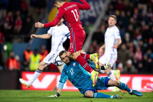 Mohamed Elyounoussi of Norway hits goalkeeper Roberts Ozols