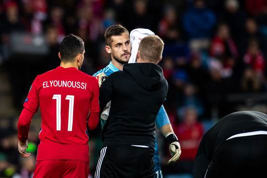 Goalkeeper Roberts Ozols of Latvia and Mohamed Elyounoussi