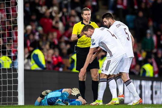Goalkeeper Roberts Ozols of Latvia in pain